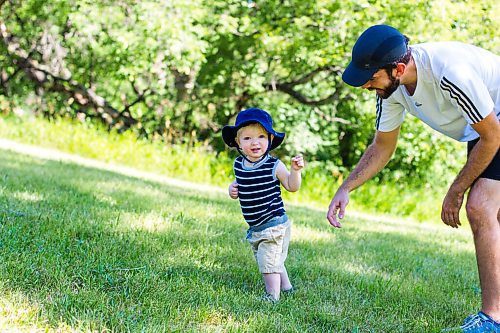 MIKAELA MACKENZIE / WINNIPEG FREE PRESS

Leland Braun, one, practices walking up and down hills with his dad, Andrew Braun, at Omand's Creek in Winnipeg on Tuesday, Aug. 18, 2020. Standup.
Winnipeg Free Press 2020.