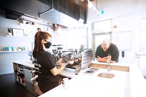 JOHN WOODS / WINNIPEG FREE PRESS
Owner Al Dawson jokes with Rae de Sousa, manager at Harrisons Coffee Co., as she makes a latte at Dawsons new coffee shop and roaster on Waterfront Drive in Winnipeg Tuesday, August 19, 2020. 

Reporter: Durrani
