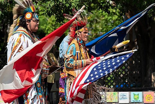 JESSE BOILY  / WINNIPEG FREE PRESS
Wayne Ruby Jr., left, and Dwayne Gladue march out the flags in the opening ceremony at the 1JustCity socially distanced Pow Wow during the lunch hour at Agnes Street and St Matthews on Thursday. Guests were asked to enjoy their lunches and watch in stead of joining in like previous years due to social distancing measures. Thursday, Aug. 20, 2020.
Reporter: Standup