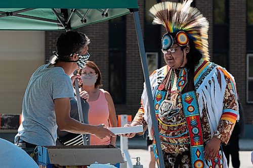 JESSE BOILY  / WINNIPEG FREE PRESS
Wayne Ruby Jr. grabs some lunch at the 1JustCity socially distanced Pow Wow during the lunch hour at Agnes Street and St Matthews on Thursday. Guests were asked to enjoy their lunches and watch in stead of joining in like previous years due to social distancing measures. Thursday, Aug. 20, 2020.
Reporter: Standup