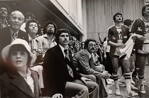 Former U of W basketball coach Bruce Enns, pictured centre in dark jacket. Supplied photo.