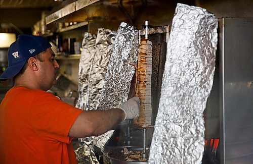 MIKE DEAL / WINNIPEG FREE PRESS
Baraka Pita at 1783 Main Street.
Badis cuts some chicken shawarma for a customer.
see Alison Gillmor story
200824 - Monday, August 24, 2020.