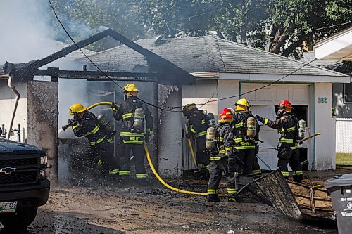 MIKE DEAL / WINNIPEG FREE PRESS
WFPS crews battle a garage fire at 366 Carpathia road which also destroyed a vehicle as well as damaged an adjacent garage Friday afternoon. No reports of injuries.
200828 - Friday, August 28, 2020.