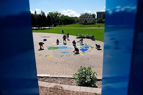 Daniel Crump / Winnipeg Free Press. Volunteers from Greenpeace Winnipeg paint a Mural at the Forks. The group is undertaking this project as a form of civil non-violent demands to demand a green and just recovery. August 29, 2020.