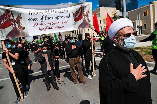 Daniel Crump / Winnipeg Free Press. Members of Winnipegs muslim community, lead by Dr. Zakaria Almoumen (right), march in commemoration of Imam Al Hussein. The march was also a protest against oppression. August 29, 2020.