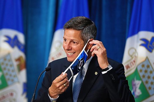 MIKE DEAL / WINNIPEG FREE PRESS
Mayor Brian Bowman puts on his mask before leaving his press conference after the Emergency Meeting of City Council Monday morning. 
200831 - Monday, August 31, 2020