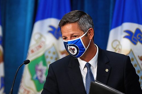 MIKE DEAL / WINNIPEG FREE PRESS
Mayor Brian Bowman puts on his mask before leaving his press conference after the Emergency Meeting of City Council Monday morning. 
200831 - Monday, August 31, 2020