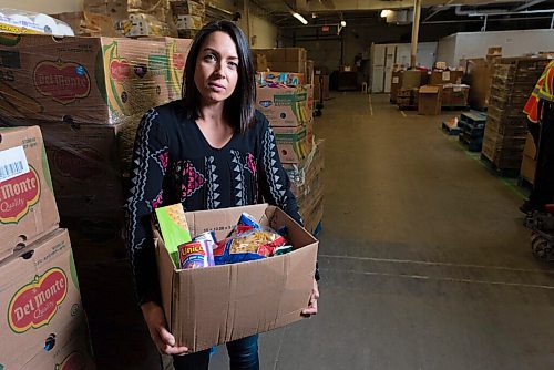 JESSE BOILY  / WINNIPEG FREE PRESS
Meaghan Erbus, advocacy and impact manager at Winnipeg Harvest, shows a hamper at the Winnipeg Harvest warehouse on Tuesday. Tuesday, Sept. 1, 2020.
Reporter: Temur