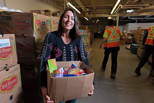 JESSE BOILY  / WINNIPEG FREE PRESS
Meaghan Erbus, advocacy and impact manager at Winnipeg Harvest, shows a hamper at the Winnipeg Harvest warehouse on Tuesday. Tuesday, Sept. 1, 2020.
Reporter: Temur