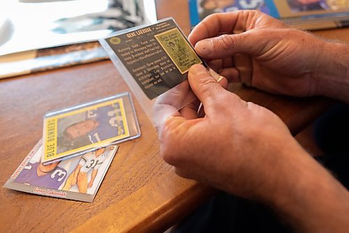 JESSE BOILY  / WINNIPEG FREE PRESS
Scott Lakusiak, son of former Bomber star Gene Lakusiak, looks at trading cards of his father at his parents home on Tuesday. Tuesday, Sept. 1, 2020.
Reporter: Doug
