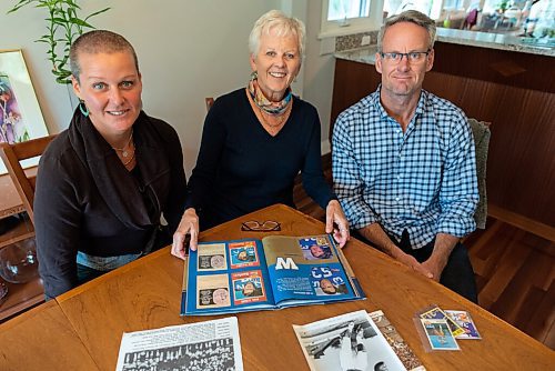 JESSE BOILY  / WINNIPEG FREE PRESS
Lyn Lakusiak, widow of former Bomber star Gene Lakusiak, goes through old photos of her husband with her children, Corey, left, and Scott at her home on Tuesday. Tuesday, Sept. 1, 2020.
Reporter: Doug