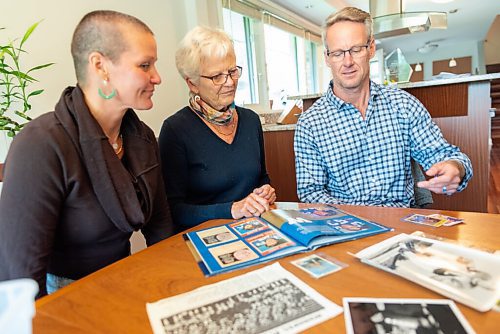 JESSE BOILY  / WINNIPEG FREE PRESS
Lyn Lakusiak, widow of former Bomber star Gene Lakusiak, goes through old photos of her husband with her children, Corey, left, and Scott at her home on Tuesday. Tuesday, Sept. 1, 2020.
Reporter: Doug