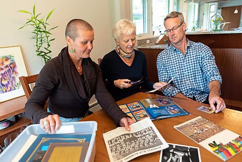 JESSE BOILY  / WINNIPEG FREE PRESS
Lyn Lakusiak, widow of former Bomber star Gene Lakusiak, goes through old photos of her husband with her children, Corey, left, and Scott at her home on Tuesday. Tuesday, Sept. 1, 2020.
Reporter: Doug