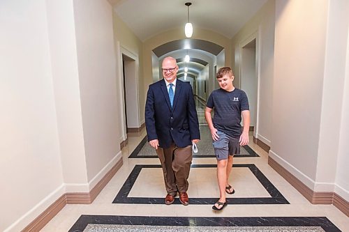 MIKAELA MACKENZIE / WINNIPEG FREE PRESS

Education minister Kelvin Goertzen and his 13-year-old son, Malachi, walk down the hallway at the Manitoba Legislative Building before the minister speaks to the media about the opening of schools next week in Winnipeg on Wednesday, Sept. 2, 2020. For Maggie Macintosh story.
Winnipeg Free Press 2020.