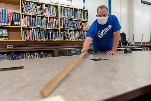 JESSE BOILY  / WINNIPEG FREE PRESS
Walter Crockford, who teaches grades 7 through 9, measures out students spots with a metre stick in the library at Andrew Mynarski V.C. School on Wednesday. Wednesday, Sept. 2, 2020.
Reporter: