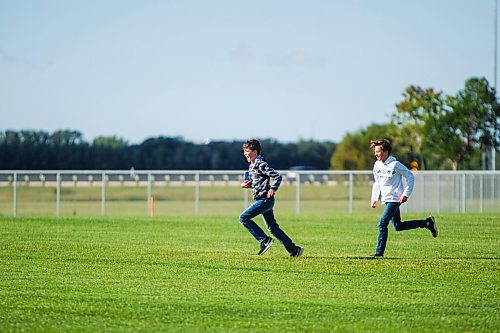 MIKAELA MACKENZIE / WINNIPEG FREE PRESS

Mayor Brian Bowman's sons, Austin (left, 10), and Hayden (12), play in the new soccer field at a ribbon cutting for the Optimist Park expansion in Winnipeg on Thursday, Sept. 3, 2020. For Joyanne story.
Winnipeg Free Press 2020.