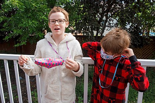 MIKE DEAL / WINNIPEG FREE PRESS
Josh Robern (right) and Rev. Meghann (left) have been prepping their two kids Prudence, 11, and Percival, 8, for wearing masks in the classroom when they return to school next week. They bought five non-medical masks for each child and have created a mask hanger in the mudroom of their home so its easy for the kids to grab one on their way out the door. 
See Eva Wasney story
200903 - Thursday, September 03, 2020.