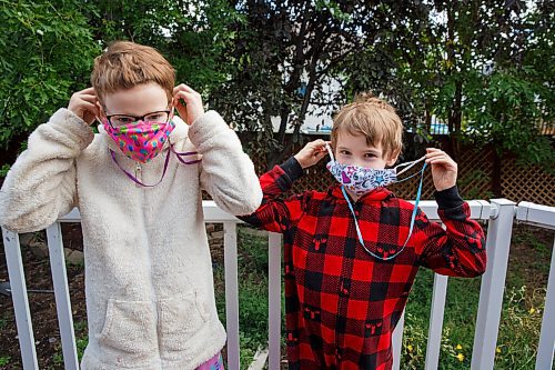 MIKE DEAL / WINNIPEG FREE PRESS
Josh Robern (right) and Rev. Meghann (left) have been prepping their two kids Prudence, 11, and Percival, 8, for wearing masks in the classroom when they return to school next week. They bought five non-medical masks for each child and have created a mask hanger in the mudroom of their home so its easy for the kids to grab one on their way out the door. 
See Eva Wasney story
200903 - Thursday, September 03, 2020.