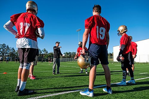 Daniel Crump / Winnipeg Free Press. University of Manitoba Bisons football team coach Brian Dobie (second from left) speaks with his quarterbacks during practice at the university. September 3, 2020.