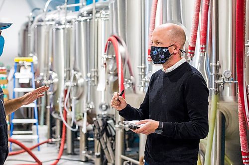 MIKAELA MACKENZIE / WINNIPEG FREE PRESS

Reporter Ben Sigurdson interviews brewery owner Andrew Sookram at Sookram's brewery in Winnipeg on Friday, Sept. 4, 2020. Sookram's is one of many local breweries with mandatory mask policies. For marketing.
Winnipeg Free Press 2020.