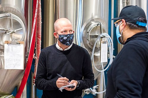 MIKAELA MACKENZIE / WINNIPEG FREE PRESS

Reporter Ben Sigurdson interviews brewery owner Andrew Sookram at Sookram's brewery in Winnipeg on Friday, Sept. 4, 2020. Sookram's is one of many local breweries with mandatory mask policies. For marketing.
Winnipeg Free Press 2020.