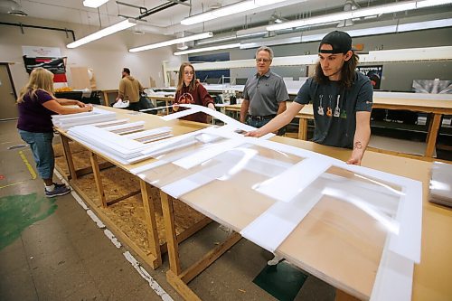 JOHN WOODS / WINNIPEG FREE PRESS
Allan Brooks, president of Light Visions, centre, looks on as Zach Skelly stacks finished versions of the companys new plastic COVID-19 desk shields intended for local schools in Winnipeg Friday, September 4, 2020. Brooks and Light Visions designed a COVID-19 desk shield for a local school and that has grown to over 10,000 in three days.

Reporter: Cash