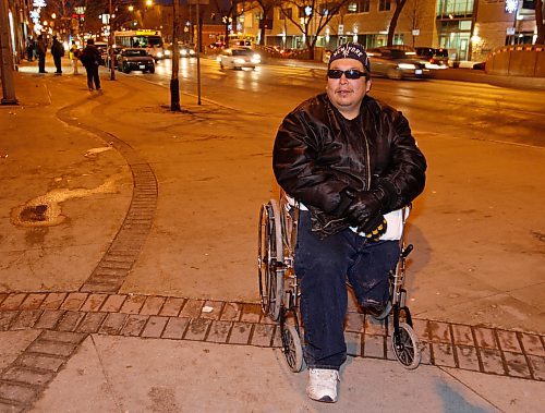 BORIS.MINKEVICH@FREEPRESS.MB.CA BORIS MINKEVICH/ WINNIPEG FREE PRESS  091123 Ronald Courchene poses for a photo in his wheelchair on Main Street in front of the Sally Ann.