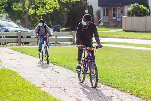 MIKAELA MACKENZIE / WINNIPEG FREE PRESS

Ridhwanlai Badmos (grade 10, right) and Rofiat Badmos (grade 12) arrive to their first day of school at Windsor Park Collegiate in Winnipeg on Tuesday, Sept. 8, 2020. The two cycled all the way from Sage Creek. For Maggie story.
Winnipeg Free Press 2020.