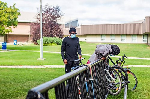 MIKAELA MACKENZIE / WINNIPEG FREE PRESS

Ridhwanlai Badmos (grade 10, left) and Rofiat Badmos (grade 12) arrive to their first day of school at Windsor Park Collegiate in Winnipeg on Tuesday, Sept. 8, 2020. The two cycled all the way from Sage Creek. For Maggie story.
Winnipeg Free Press 2020.