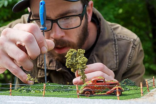 MIKE DEAL / WINNIPEG FREE PRESS
Dan fixes a tree in a diorama that includes a '34 Ford. 
Daniel Walker, a member of 204HotWheels, a local group devoted to Hot Wheels cars (about 600 members in the city). What sets Daniel apart from the rest is that besides collecting cars, he also has gotten into customizing Hot Wheels, swapping out tires, inserting engines, and repainting. He also makes small dioramas turning Hot Wheel cars into old rusted cars that look like they have been abandoned in a field.
200909 - Wednesday, September 09, 2020.
