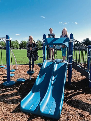 Canstar Community News From left: Hailey, Abigail and Mia Schellenberg were among the first current and former students of Joseph Teres School to try out the schools new playstructure on Aug. 31. (SHELDON BIRNIE/CANSTAR/THE HERALD)