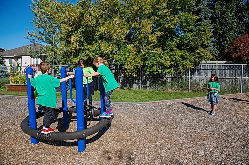 MIKE DEAL / WINNIPEG FREE PRESS
Kids in the Green cohort on the playground at Linden Meadows school Friday morning.
Linden Meadows school has assigned cohorts colours and is requiring students to clothing in a specific shade so teachers can tell groups apart and redirect students if they get mixed up on the playground. 
See Maggie story
200911 - Friday, September 11, 2020.