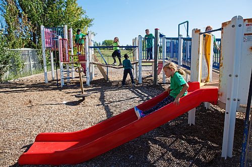 MIKE DEAL / WINNIPEG FREE PRESS
Kids in the Green cohort on the playground at Linden Meadows school Friday morning.
Linden Meadows school has assigned cohorts colours and is requiring students to clothing in a specific shade so teachers can tell groups apart and redirect students if they get mixed up on the playground. 
See Maggie story
200911 - Friday, September 11, 2020.