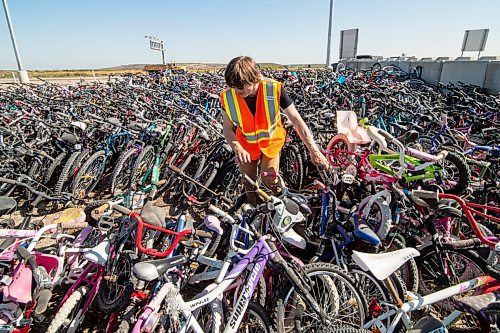 Mike Sudoma / Winnipeg Free Press
WRENCH Back to School Build-A-Thon volunteer, Mathew Gervais, looks through the massive supply of bikes that have been discarded to find a suitable bike to refurbish and get backing the hands of a new owner.
September 12, 2020