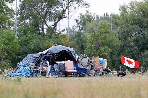 JOHN WOODS / WINNIPEG FREE PRESS
A person walks past a tent at a homeless camp on Higgins in Winnipeg Monday, September 14, 2020. 

Reporter:?