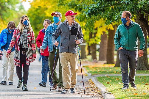 MIKAELA MACKENZIE / WINNIPEG FREE PRESS

Winnipeg arts lover Douglas MacEwan (centre, with hiking poles) talks to Julian Pellicano, associate conductor of the Winnipeg Symphony Orchestra, while walking in his neighbourhood with arts directors and friends in Winnipeg on Tuesday, Sept. 15, 2020. MacEwan is walking one kilometer every day for 96 days in order to raise $96,000 to be divided evenly between Winnipegs four major performing arts organizations (Manitoba Opera, the Royal Manitoba Theatre Centre, Royal Winnipeg Ballet, and the Winnipeg Symphony Orchestra). For Eva Wasney story.
Winnipeg Free Press 2020.