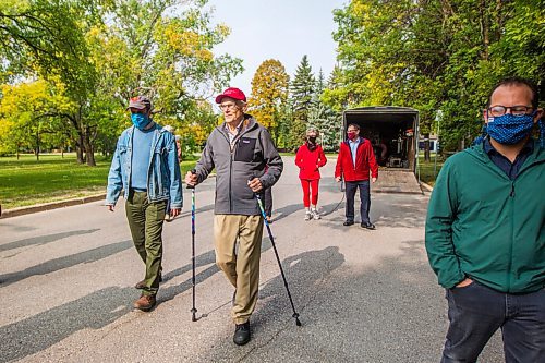 MIKAELA MACKENZIE / WINNIPEG FREE PRESS

Winnipeg arts lover Douglas MacEwan (centre, with hiking poles) walks in his neighbourhood with arts directors and friends André Lewis (left), Susan Glass, James MacEwan, and Julian Pellicano in Winnipeg on Tuesday, Sept. 15, 2020. MacEwan is walking one kilometer every day for 96 days in order to raise $96,000 to be divided evenly between Winnipegs four major performing arts organizations (Manitoba Opera, the Royal Manitoba Theatre Centre, Royal Winnipeg Ballet, and the Winnipeg Symphony Orchestra). For Eva Wasney story.
Winnipeg Free Press 2020.