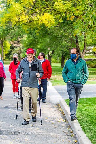 MIKAELA MACKENZIE / WINNIPEG FREE PRESS

Winnipeg arts lover Douglas MacEwan (centre, with hiking poles) talks to Julian Pellicano, associate conductor of the Winnipeg Symphony Orchestra, while walking in his neighbourhood with arts directors and friends in Winnipeg on Tuesday, Sept. 15, 2020. MacEwan is walking one kilometer every day for 96 days in order to raise $96,000 to be divided evenly between Winnipegs four major performing arts organizations (Manitoba Opera, the Royal Manitoba Theatre Centre, Royal Winnipeg Ballet, and the Winnipeg Symphony Orchestra). For Eva Wasney story.
Winnipeg Free Press 2020.