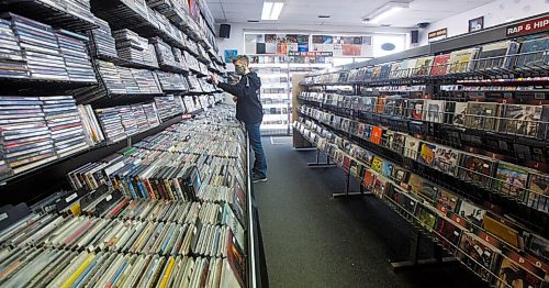 MIKE DEAL / WINNIPEG FREE PRESS
Store manager, Cathie Stankey, organizes some CD's.
Planet of Sound, 201-1109 Henderson Hwy, an entertainment emporium celebrating its 20th anniversary this year. When Dave Wright started the store in 2000, it was primarily CDs, DVDs and VHS tapes. Vinyl joined the party about 10 years ago and are now a big part of sales.
see Dave Sanderson story
200915 - Tuesday, September 15, 2020.