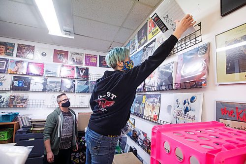 MIKE DEAL / WINNIPEG FREE PRESS
Dave Wright watches as store manager, Cathie Stankey, puts another album on the wall...
Planet of Sound, 201-1109 Henderson Hwy, an entertainment emporium celebrating its 20th anniversary this year. When Dave Wright started the store in 2000, it was primarily CDs, DVDs and VHS tapes. Vinyl joined the party about 10 years ago and are now a big part of sales.
see Dave Sanderson story
200915 - Tuesday, September 15, 2020.