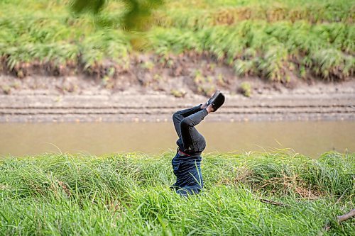 Mike Sudoma / Winnipeg Free Press
NAfro dancer, Amara Conde, mid back hand spring as he practices his routine along along the river banks of the St Norbert Arts Centre while he and his dance group get ready to perform their production, MATOPE Friday evening  
September 18, 2020