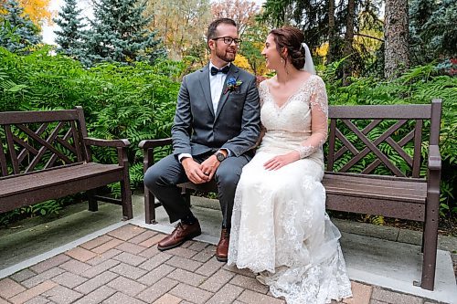 Daniel Crump / Winnipeg Free Press. Kraig Wiebe (left) and Kaitlyn Heuring (right) pose for photos after their wedding ceremony at the Leo Mol sculpture garden. With stronger COVID-19 restrictions coming into force on Monday many other couples may have to change their wedding plans. September 26, 2020.