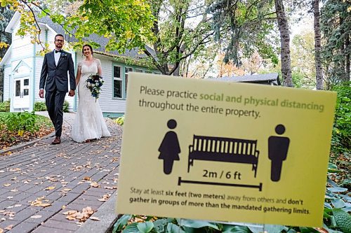Daniel Crump / Winnipeg Free Press. Kraig Wiebe (left) and Kaitlyn Heuring (right) pose for photos after their wedding ceremony at the Leo Mol sculpture garden. With stronger COVID-19 restrictions coming into force on Monday many other couples may have to change their wedding plans. September 26, 2020.