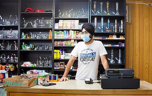 MIKE DEAL / WINNIPEG FREE PRESS
Prabjot Singh an employee at the corner store, Strikers deli and meats, on Burrows Avenue, Monday morning the first day that masks need to be worn inside public spaces. The province has mandated that the Winnipeg Metropolitan Region be downgraded to the Pandemic Response System level, Restricted (Orange) for the next four weeks.
200928 - Monday, September 28, 2020.