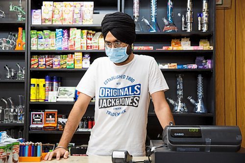 MIKE DEAL / WINNIPEG FREE PRESS
Prabjot Singh an employee at the corner store, Strikers deli and meats, on Burrows Avenue, Monday morning the first day that masks need to be worn inside public spaces. The province has mandated that the Winnipeg Metropolitan Region be downgraded to the Pandemic Response System level, Restricted (Orange) for the next four weeks.
200928 - Monday, September 28, 2020.