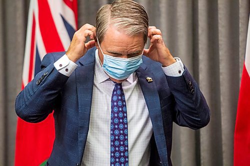 MIKAELA MACKENZIE / WINNIPEG FREE PRESS

Health, seniors, and active living minister Cameron Friesen puts on his mask after speaking to the media at the Manitoba Legislative Building in Winnipeg on Monday, Sept. 28, 2020. For Carol Sanders story.

Winnipeg Free Press 2020