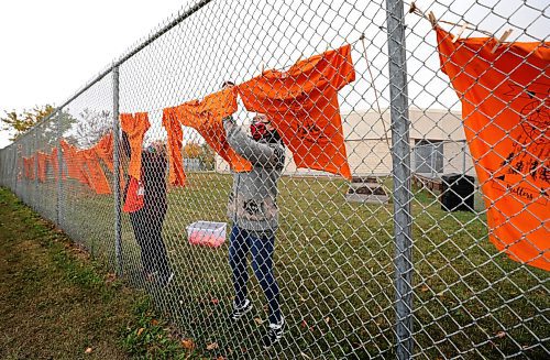 RUTH BONNEVILLE / WINNIPEG FREE PRESS
 
Standup  - Orange Shirt Day

Ecole Lavallee (School) support workers, Katelyn Combs (Right, Community service) and Rhonda Temple (Library Assistant), hang orange shirts and signs on the school fence facing St. Annes Rd. in recognition of Orange Shirt Day (Every Sept. 30 ) on Wednesday.    

ORANGE SHIRT DAY: Orange Shirt Day is an event, created in 2013, designed to educate people and promote awareness in Canada about the Indian residential school system and the impact it has had on Indigenous communities.


Sept 30th,, 2020