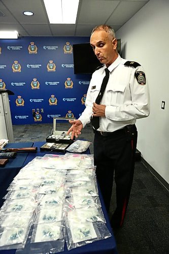 MIKE DEAL / WINNIPEG FREE PRESS
Winnipeg Police Inspector Max Waddell with drugs and guns that were collected during the arrest in June of three men involved in drug trafficking. 
201002 - Friday, October 2, 2020.