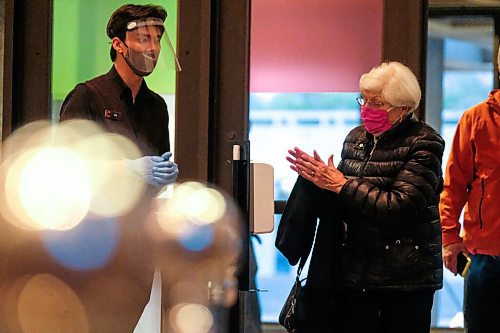 Daniel Crump / Winnipeg Free Press. Janice Lutz applies hand sanitizer as she enters the Centennial Concert Hall on opening night of the Winnipeg Symphony ORchestras first concert since COVID shut them down in March. October 2, 2020.