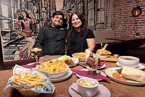 JESSE BOILY  / WINNIPEG FREE PRESS
Payam Jamali and his wife Mona Naghibzadeh owners of the cafe stop for photo infant of some of their dishes at the Next Stop Cafe on Friday. The restaurant hosts a variety of foods from 14 different types of burgers to Iranian street food. Friday, Oct. 2, 2020.
Reporter:Alison Gillmor